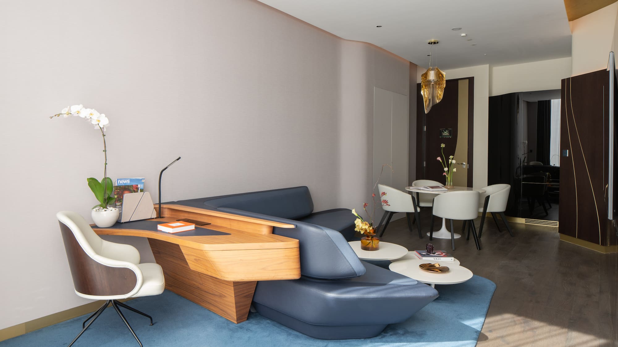 a room with a couch and chairs