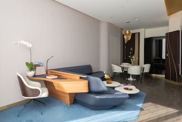 a room with a couch and chairs