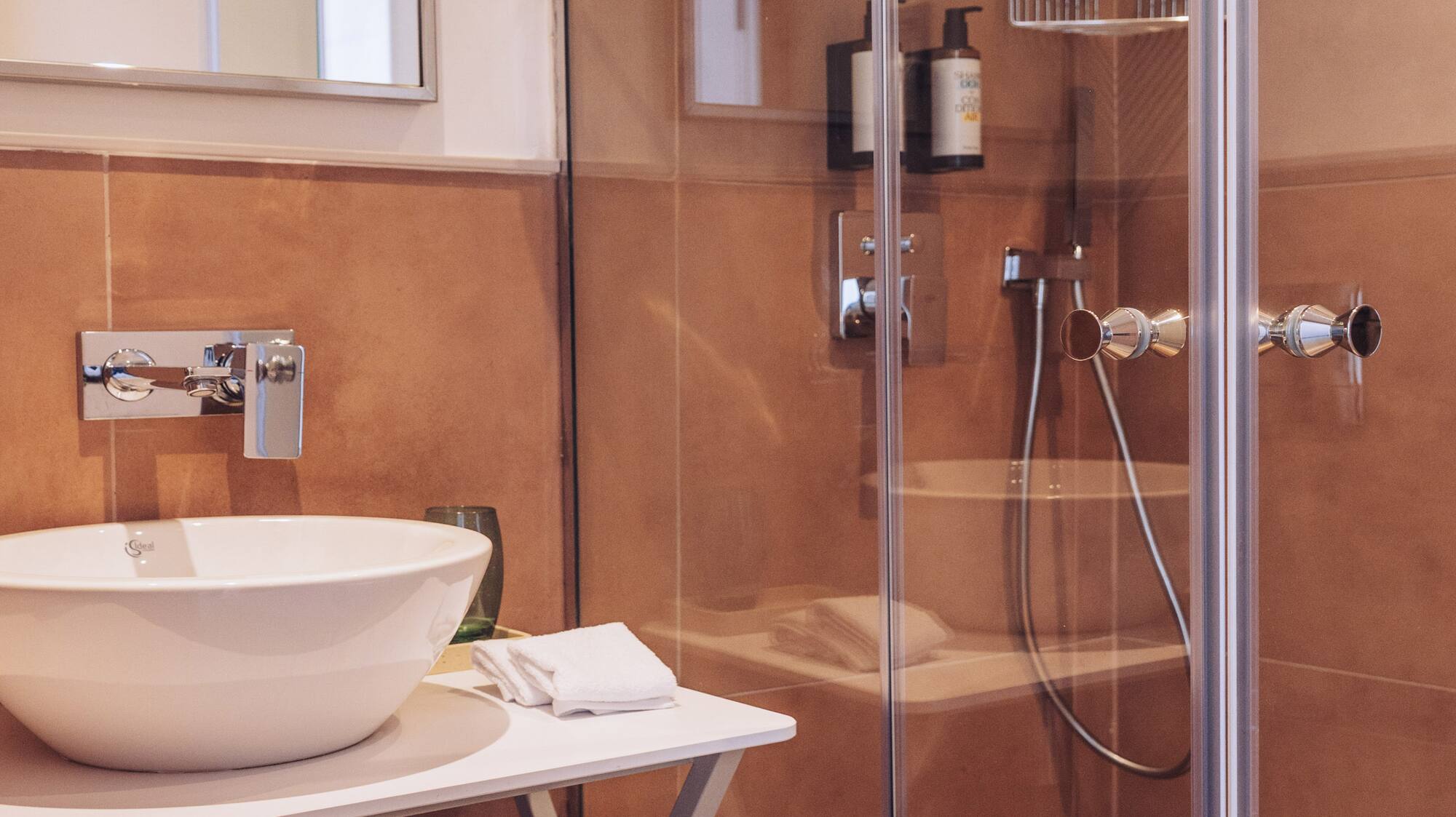 a bathroom with a glass shower and sink