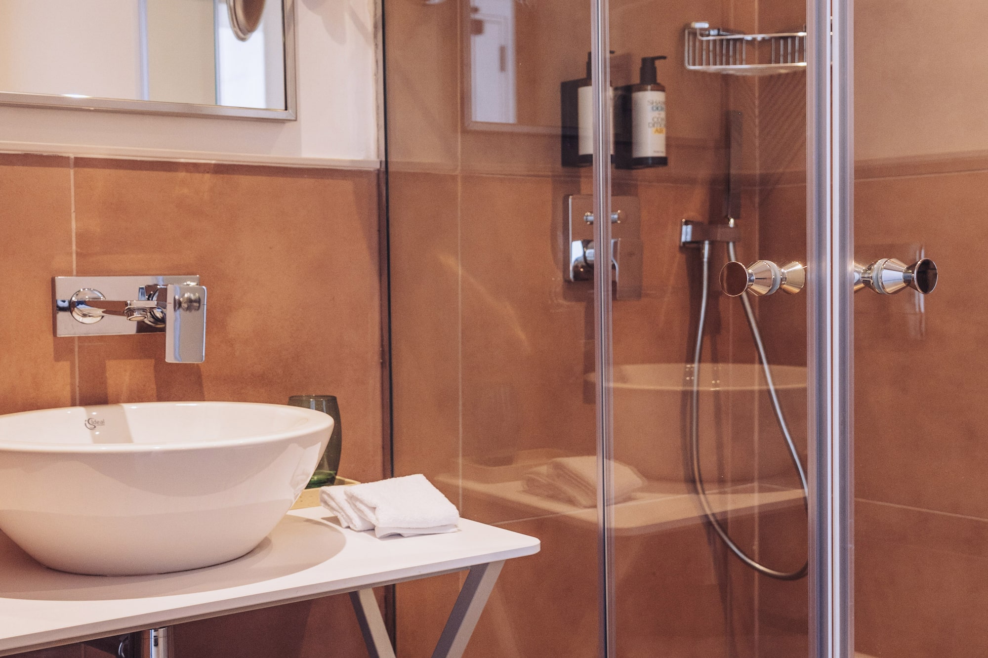a bathroom with a glass shower and sink