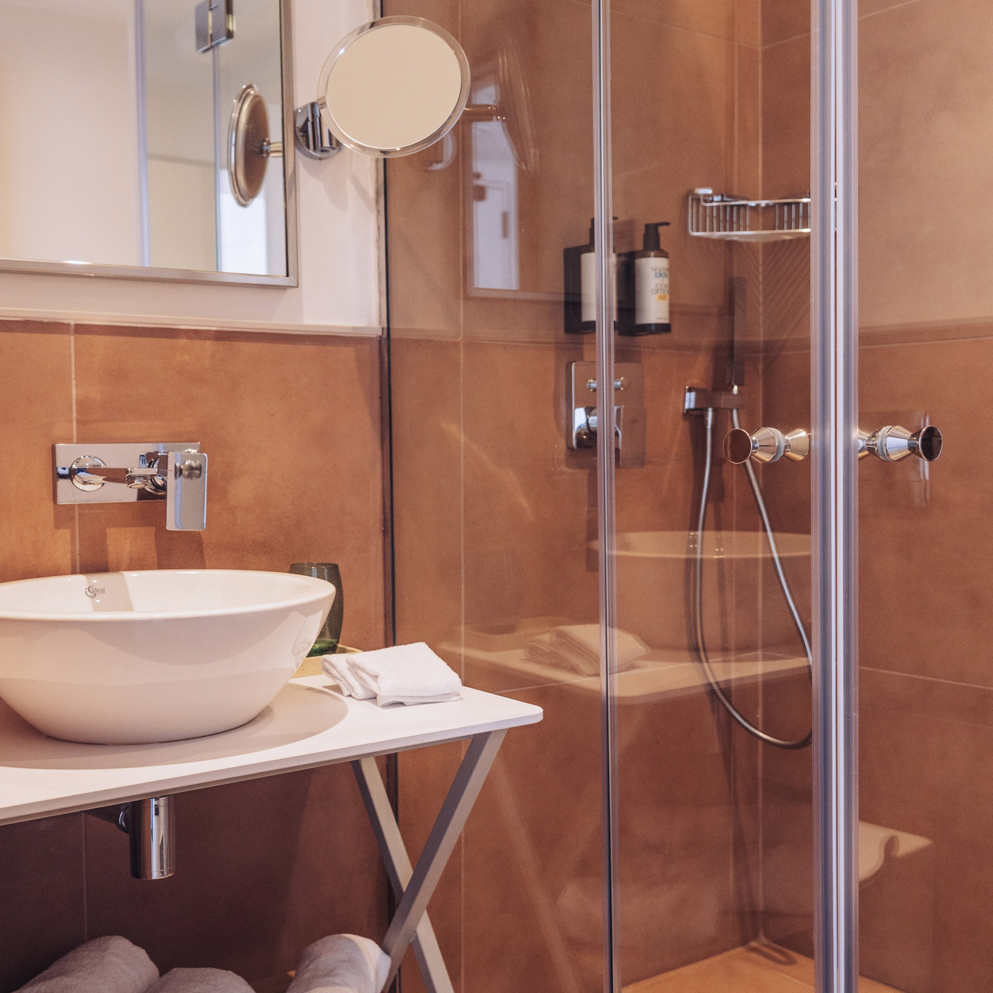 a bathroom with a glass shower and sink