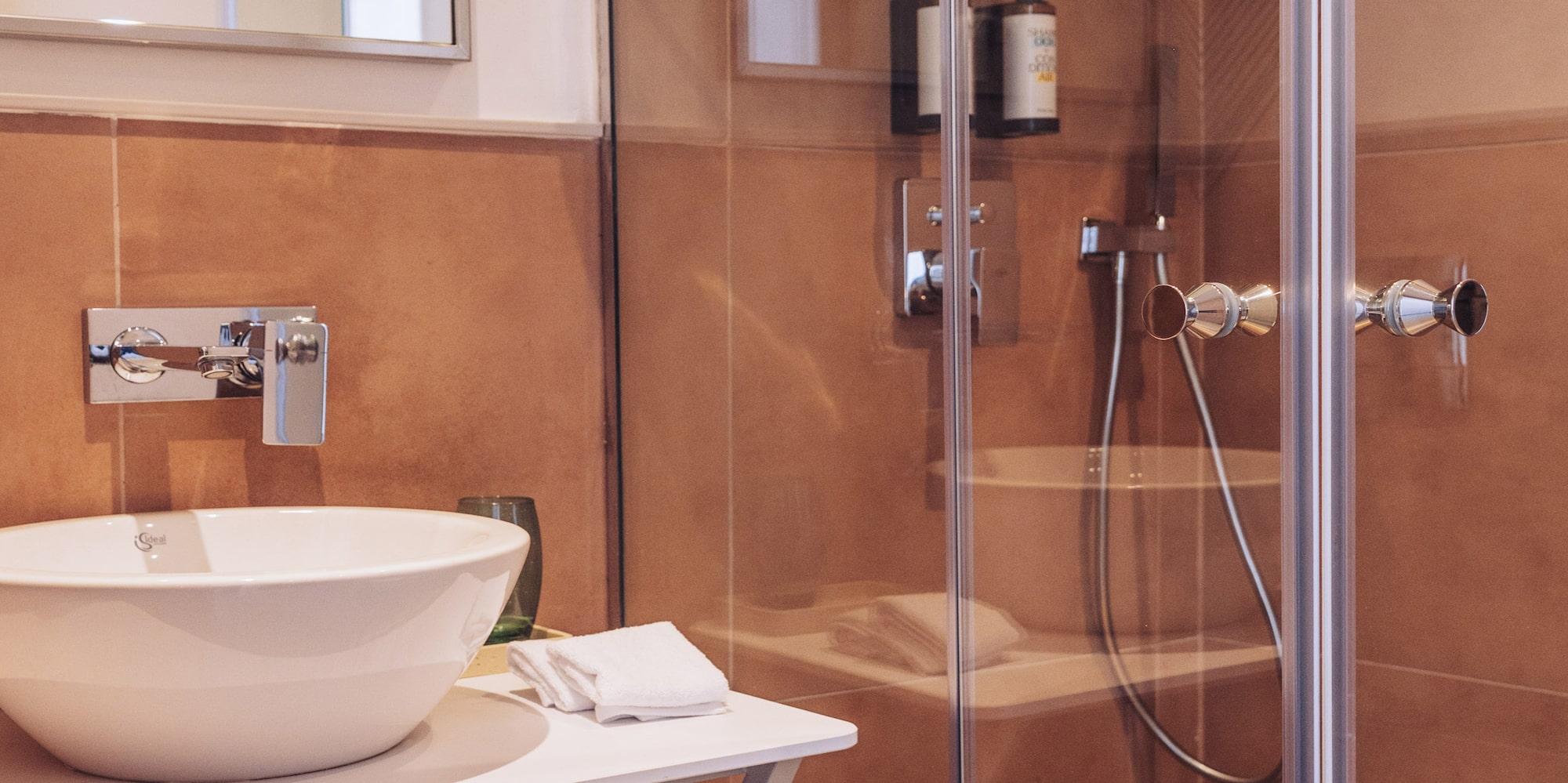a bathroom with a glass shower and sink
