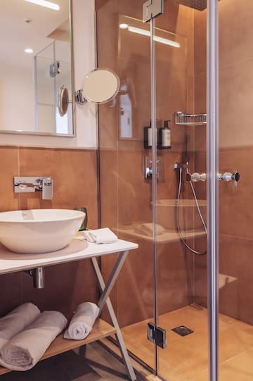 a bathroom with a glass shower and sink
