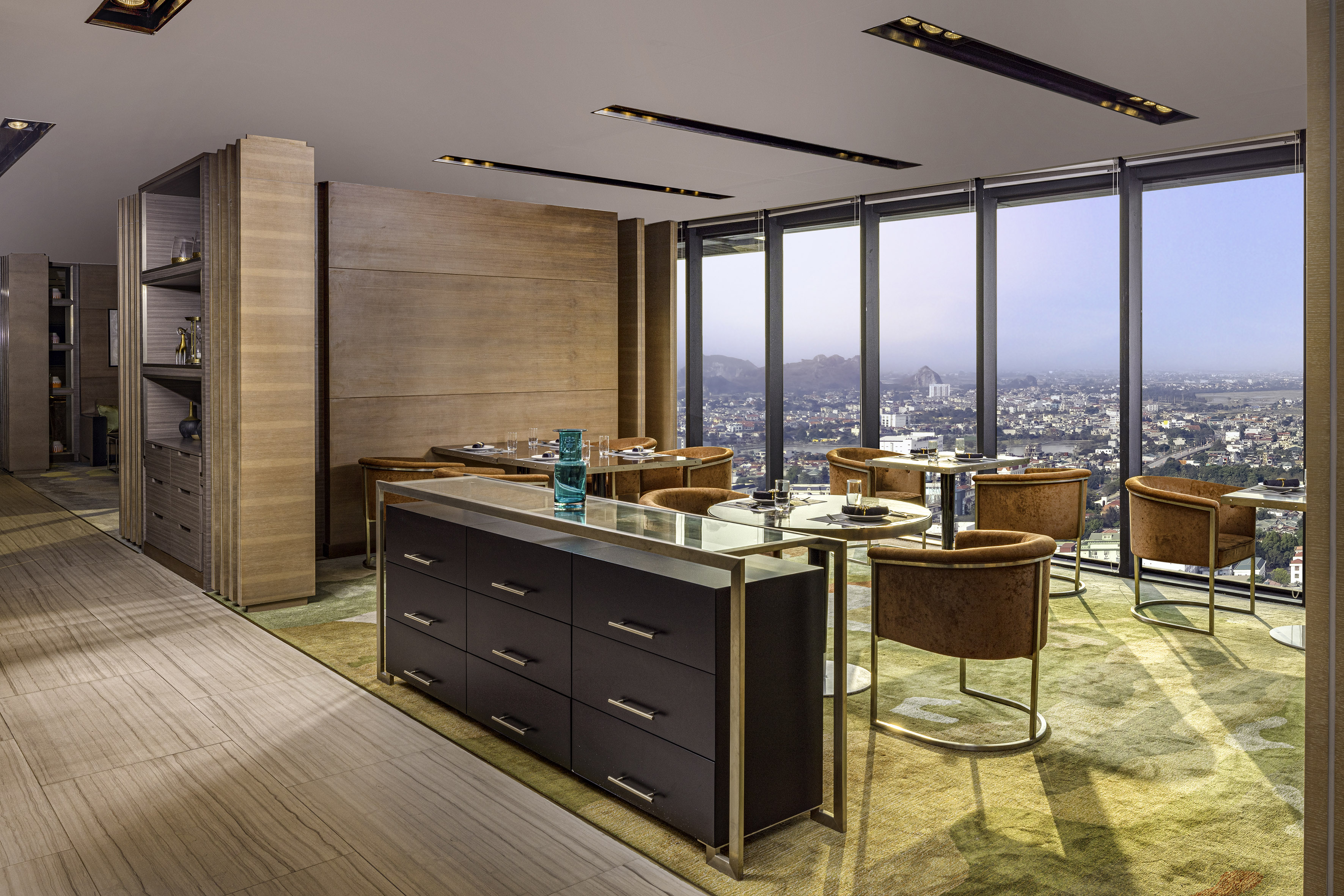 Elegant restaurant with city skyline view, modern dining setup, and wood paneling.