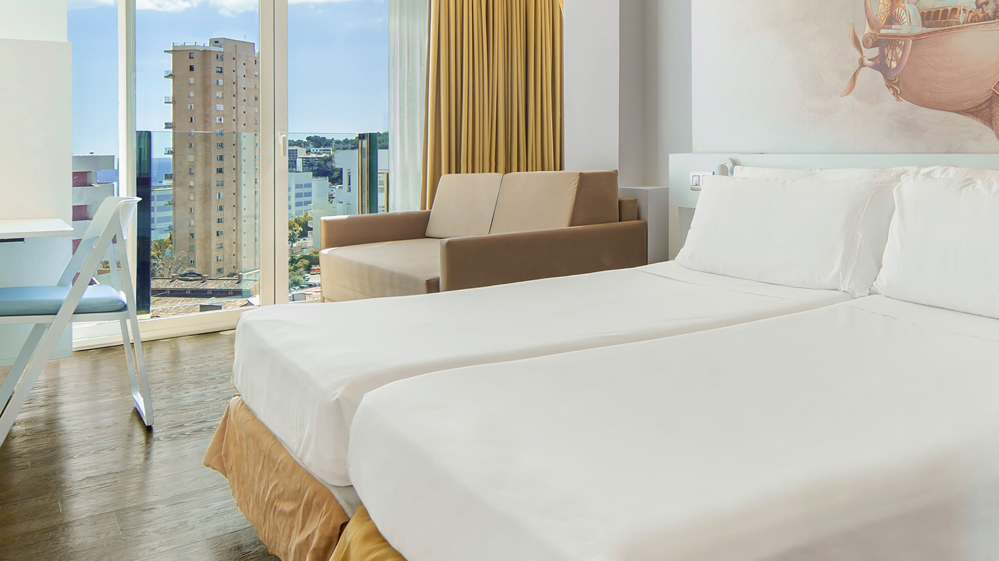 a room with two beds and a picture on the wall