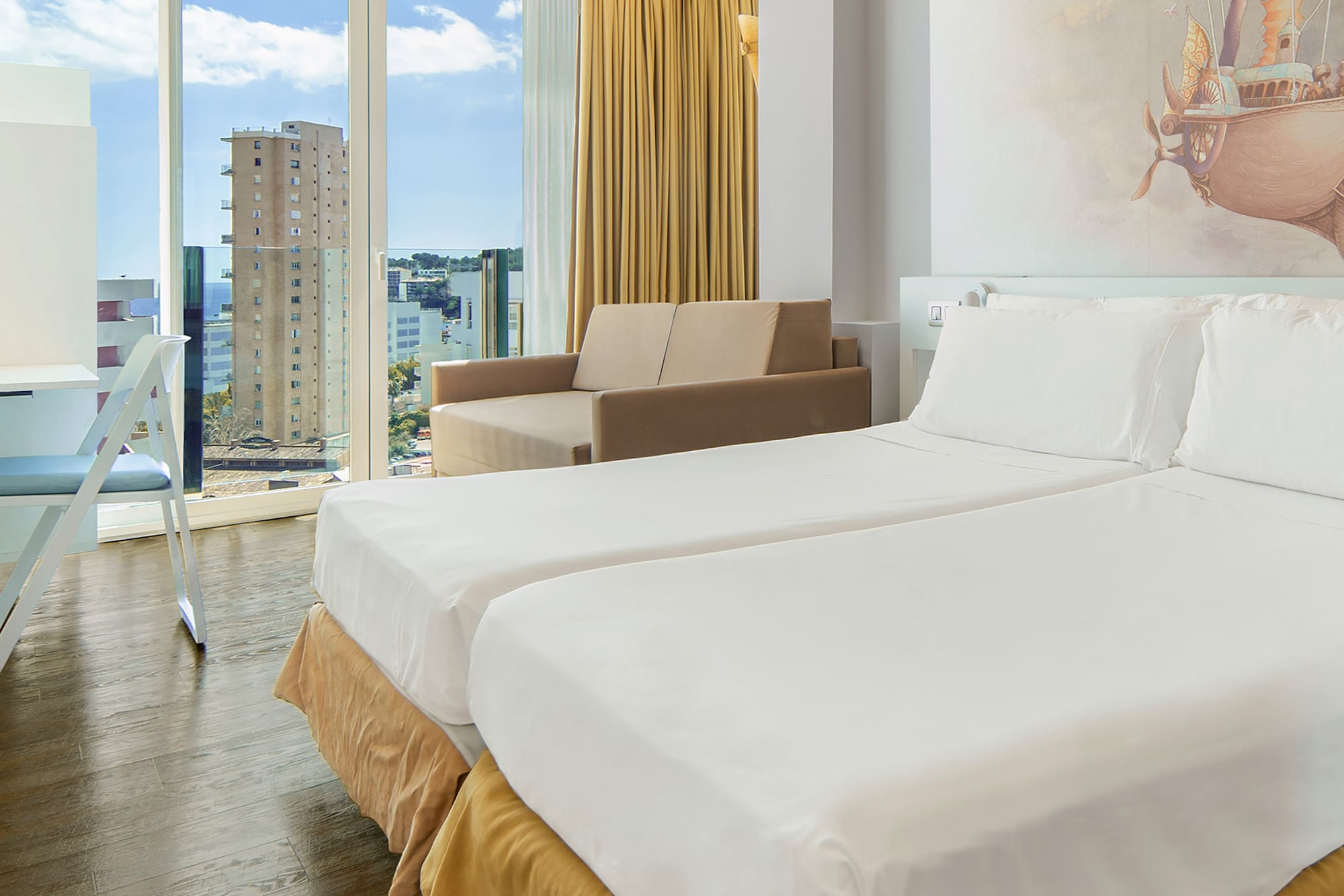 a room with two beds and a picture on the wall