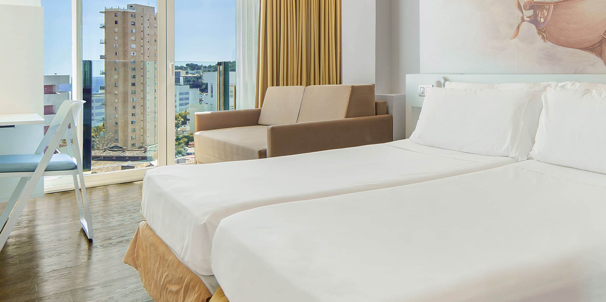 a room with two beds and a picture on the wall