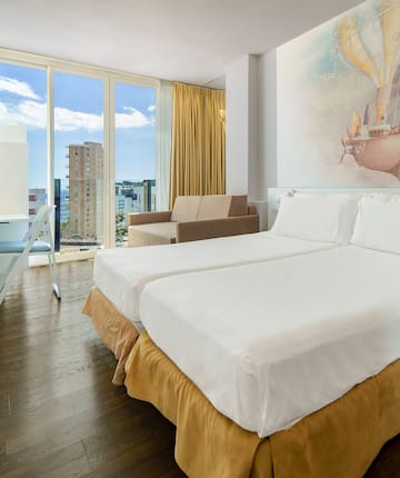 a room with two beds and a picture on the wall