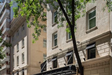 a building with trees and a tree in the background