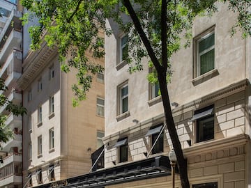 a building with trees and a tree in the background