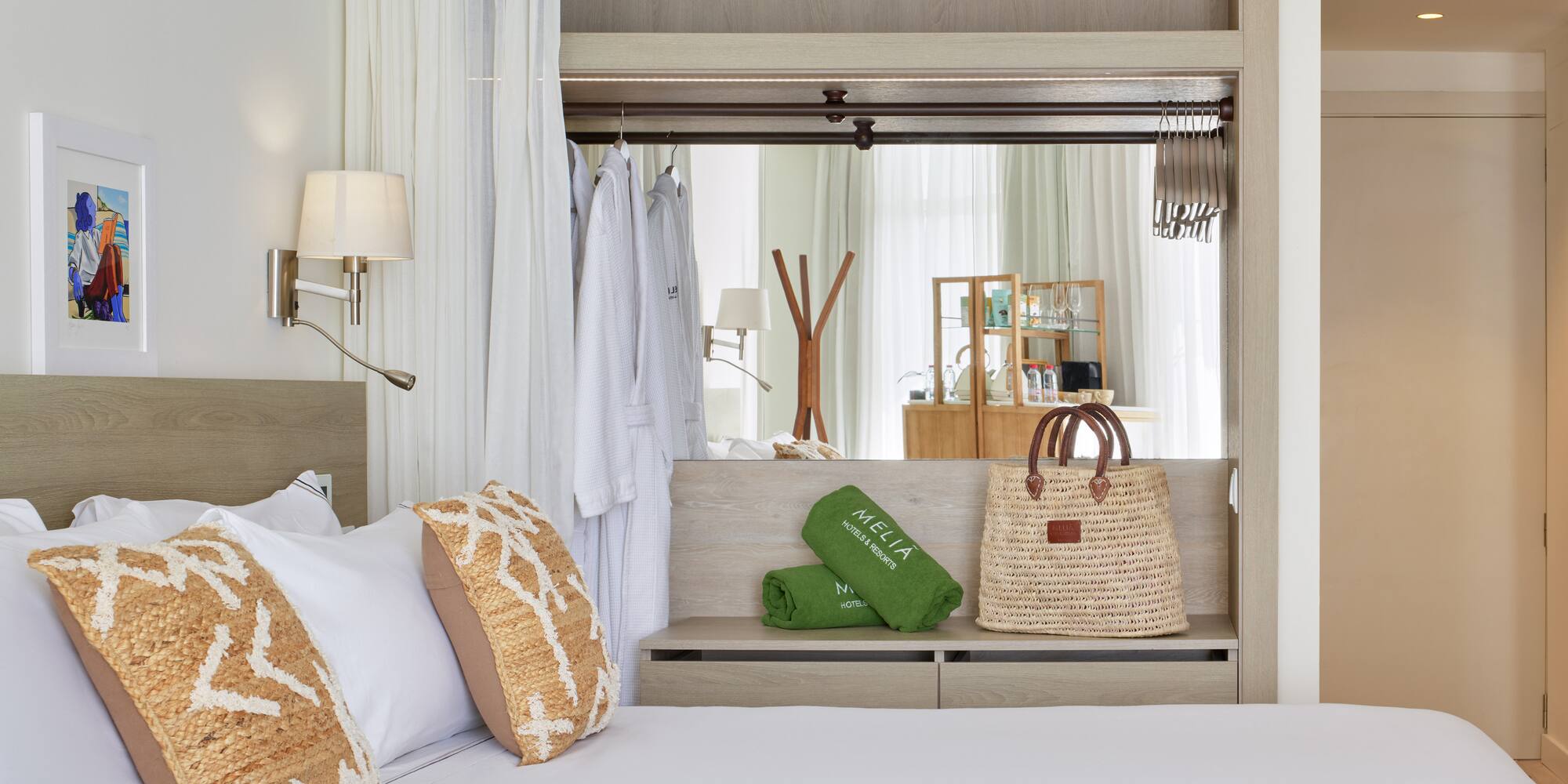 a bed with white sheets and brown pillows