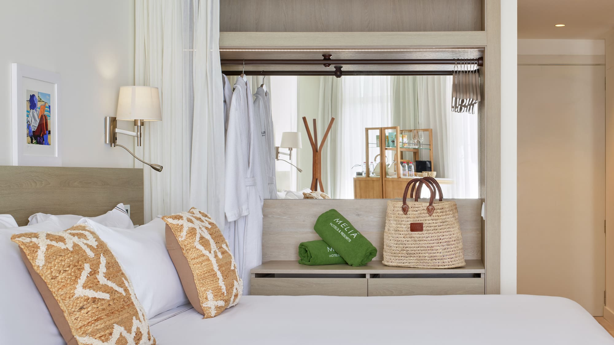 a bed with white sheets and brown pillows