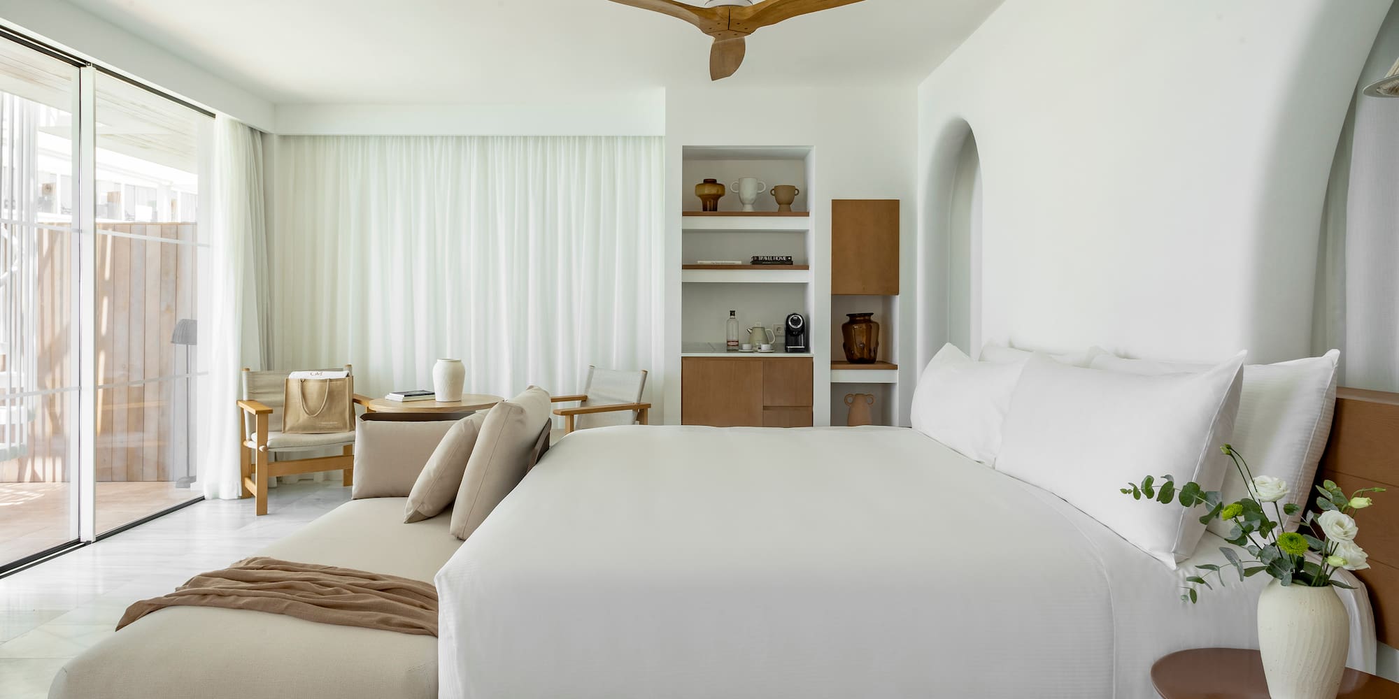 a room with a bed and a fan