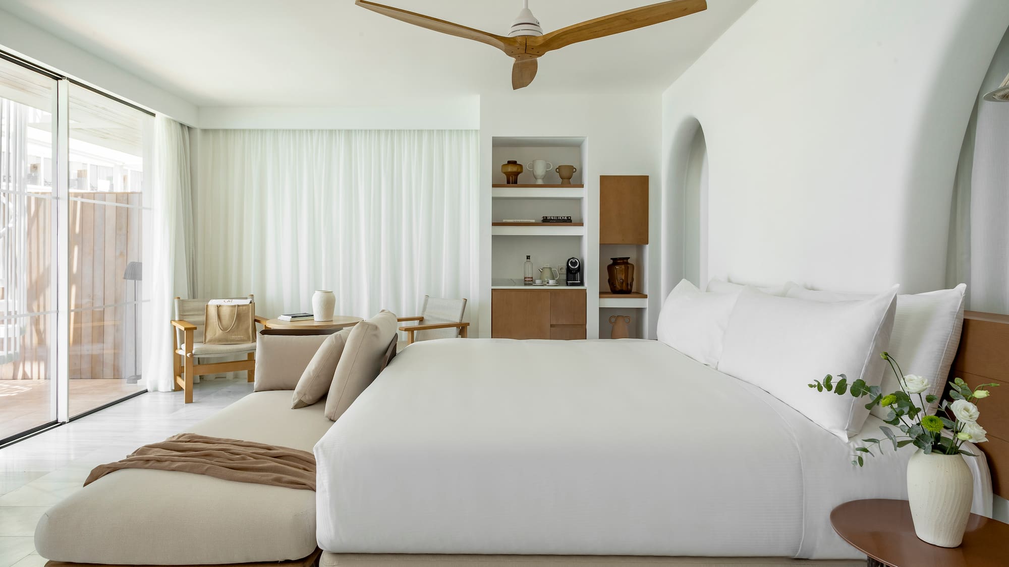 a room with a bed and a fan