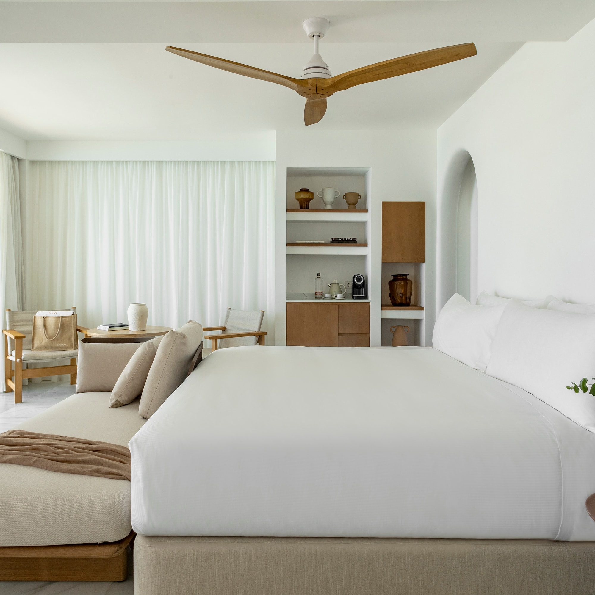 a room with a bed and a fan