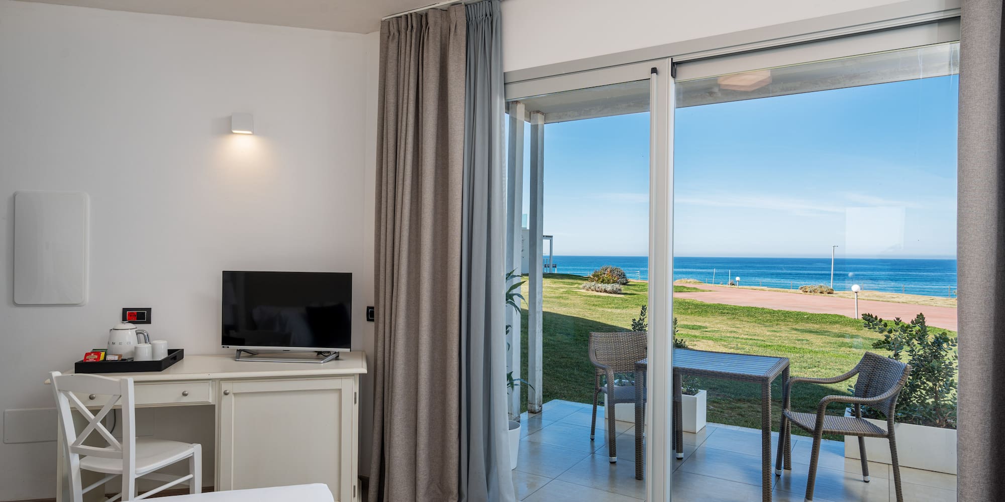 a room with a sliding glass door and a table and chairs