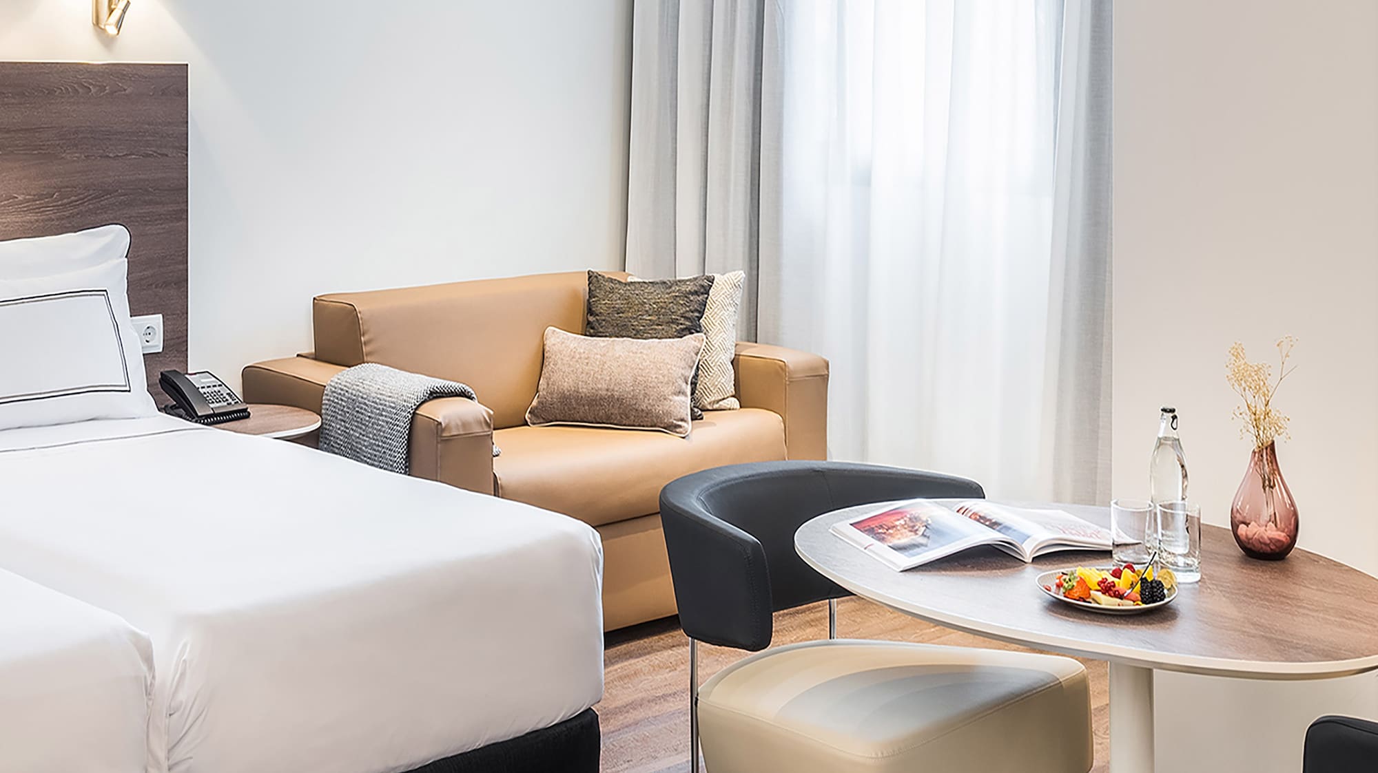 a room with two beds and a round table