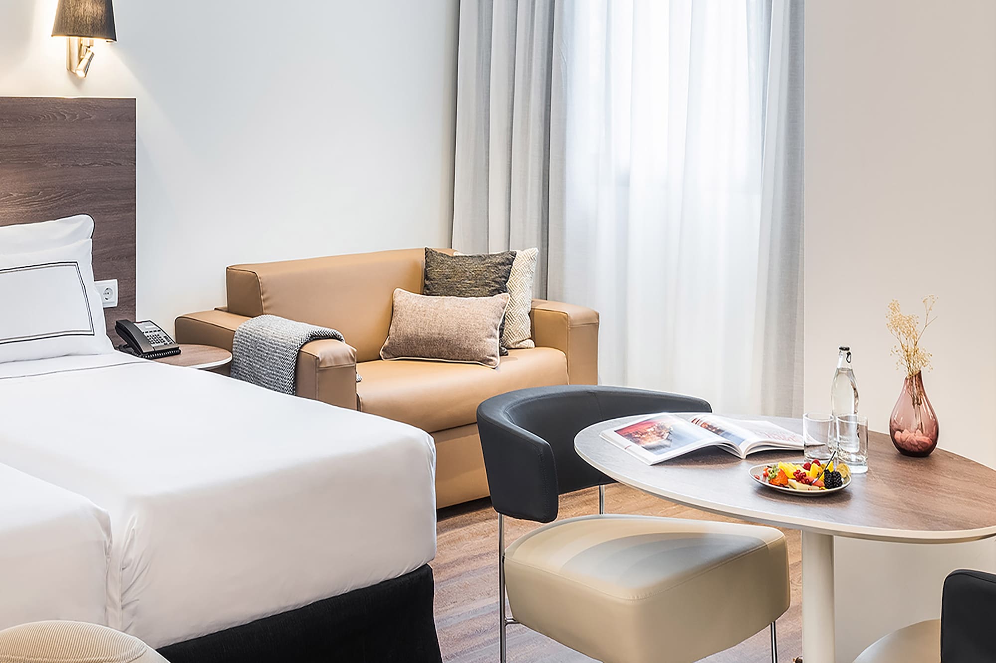 a room with two beds and a round table