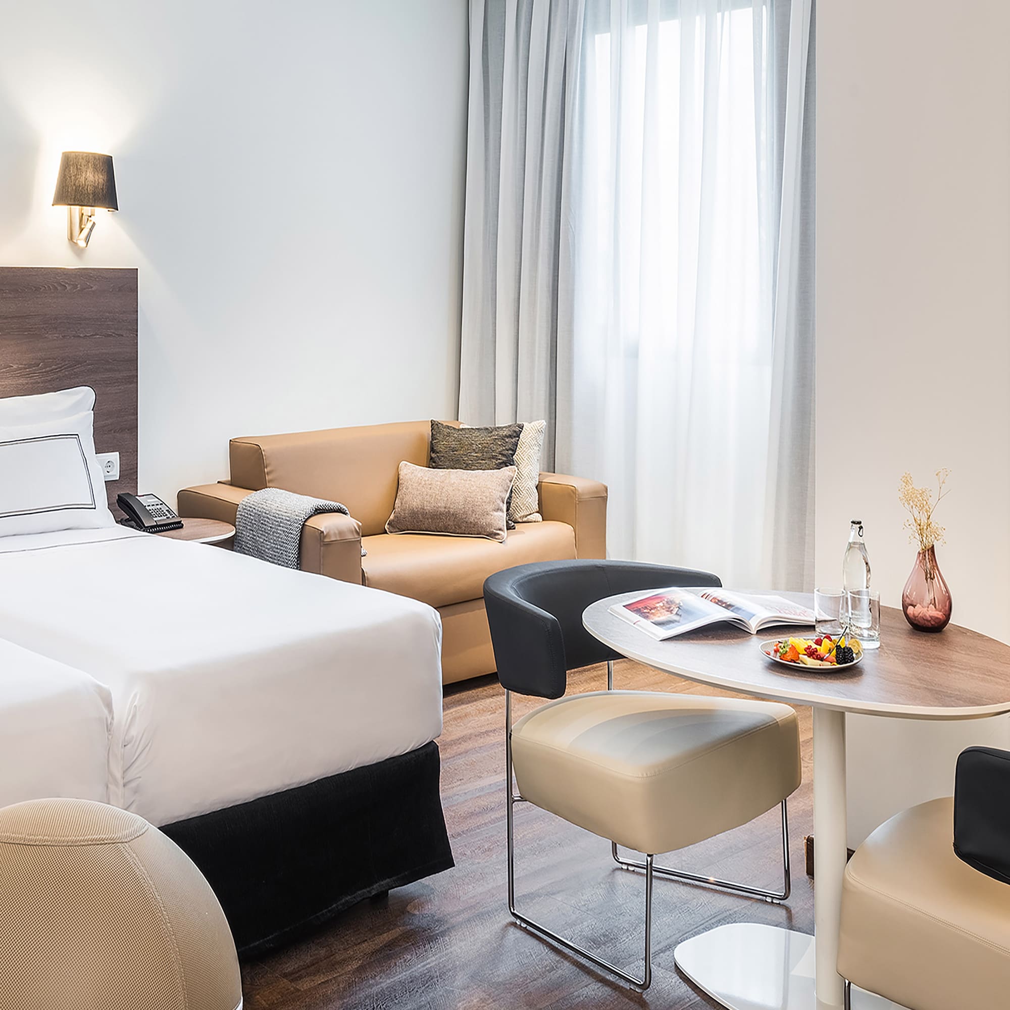 a room with two beds and a round table