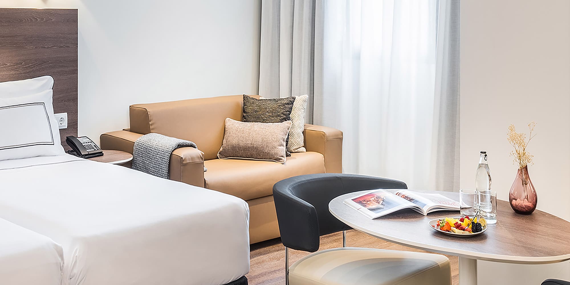 a room with two beds and a round table