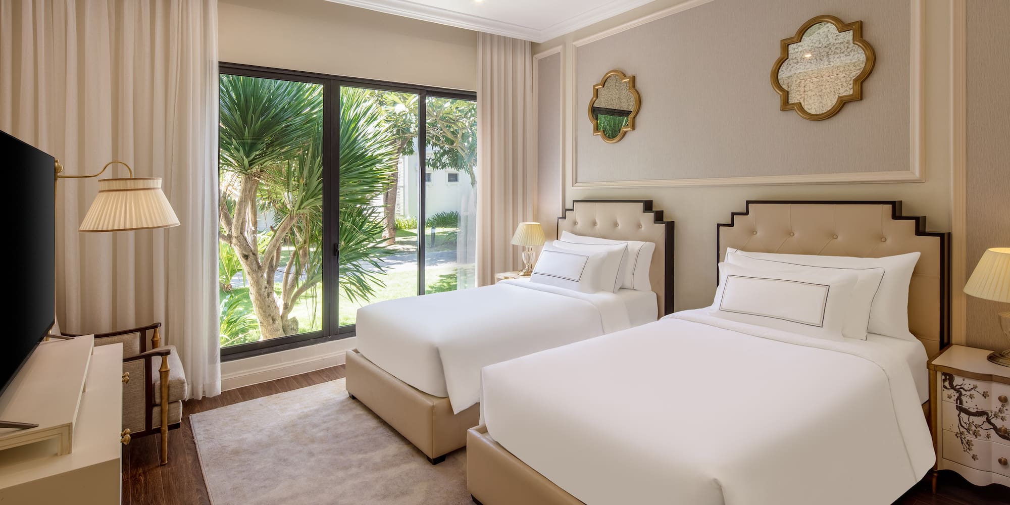 a room with two beds and a glass door