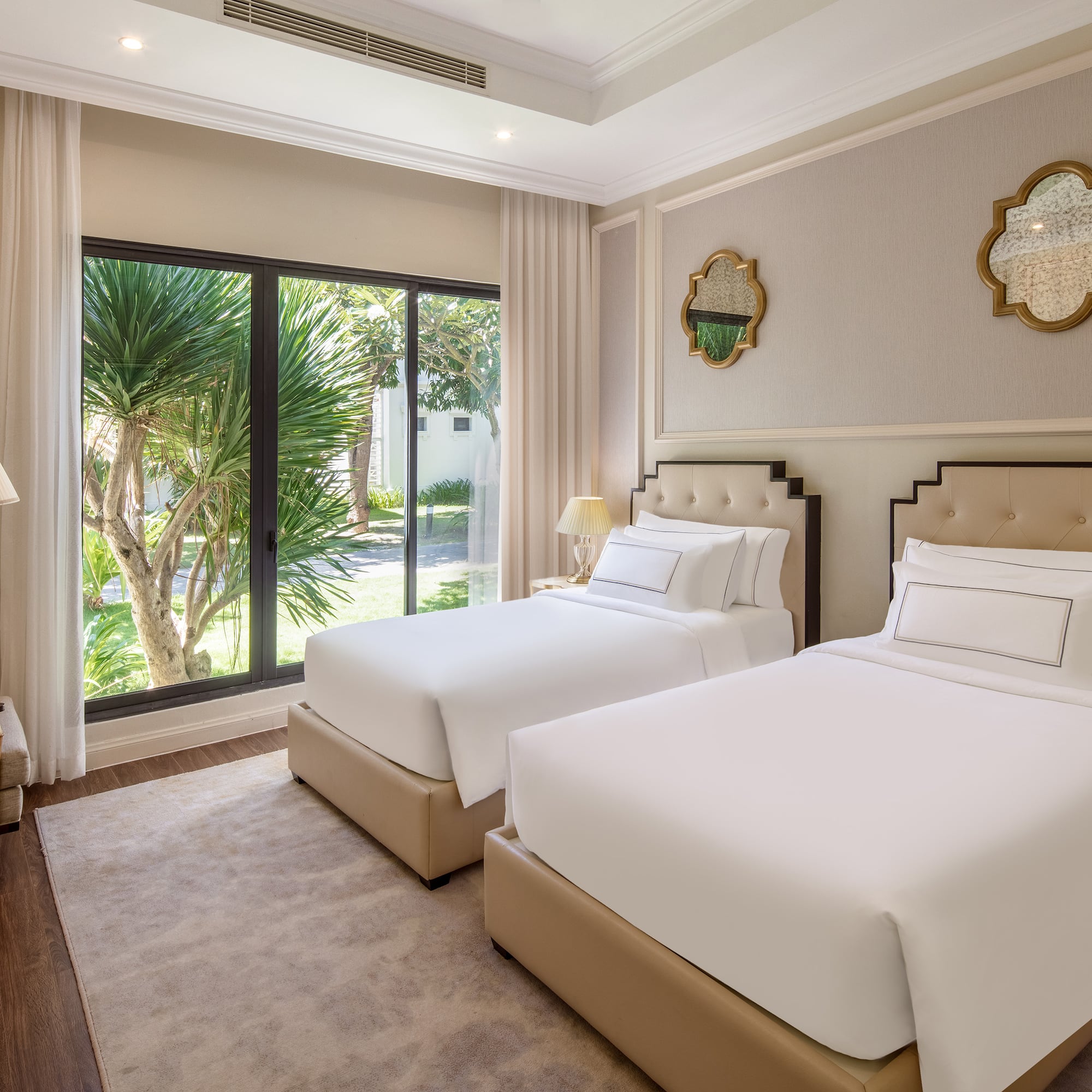 a room with two beds and a glass door