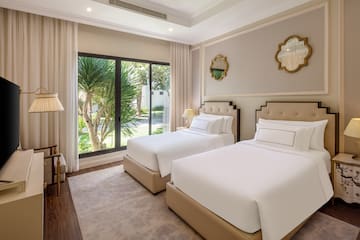 a room with two beds and a glass door