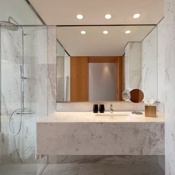 a bathroom with a marble countertop and a shower