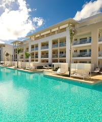 a pool with a building and a blue sky