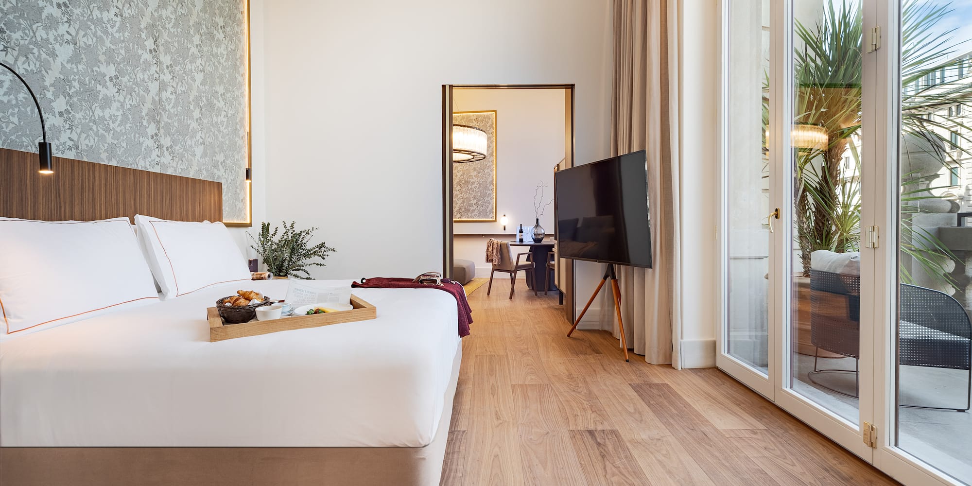 a bedroom with a tv and a tray of food