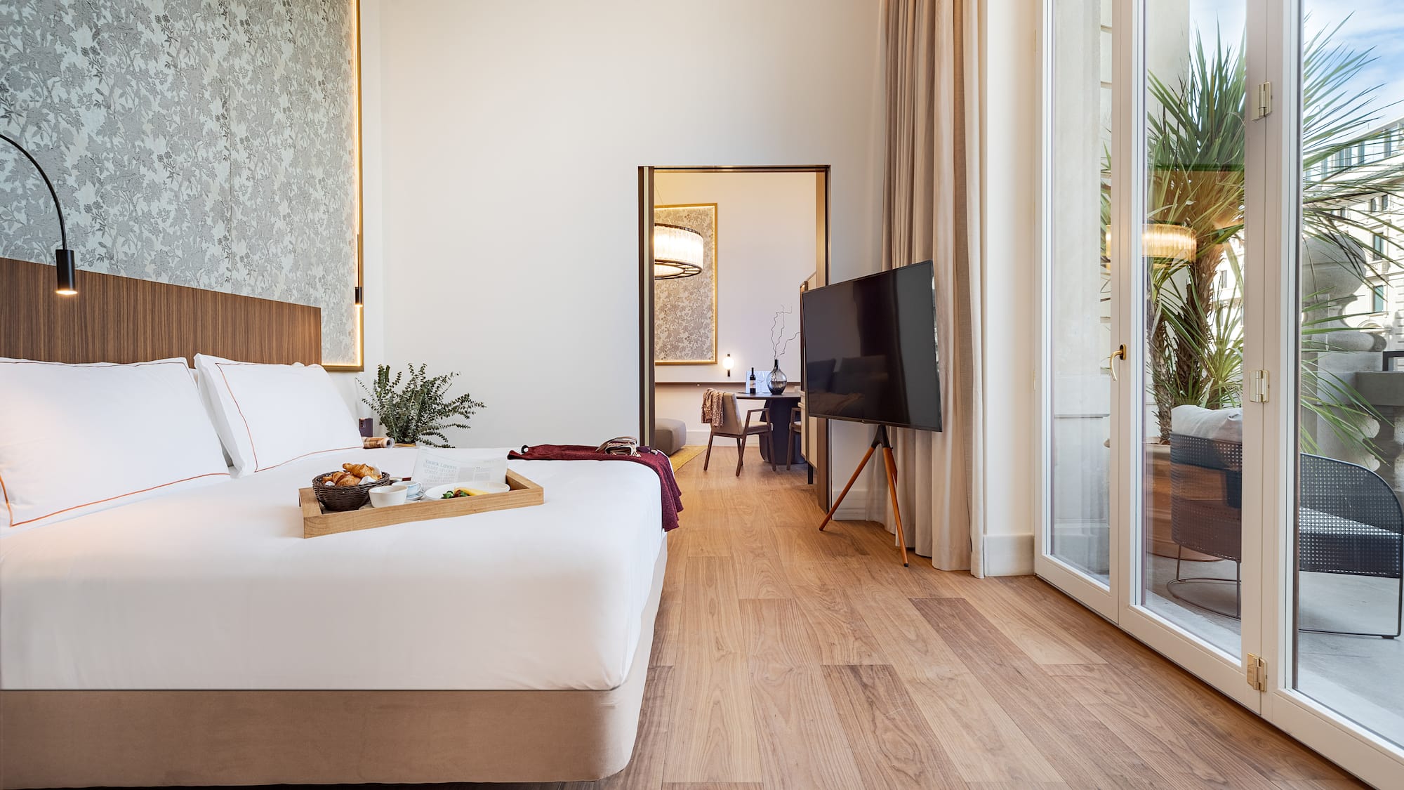 a bedroom with a tv and a tray of food