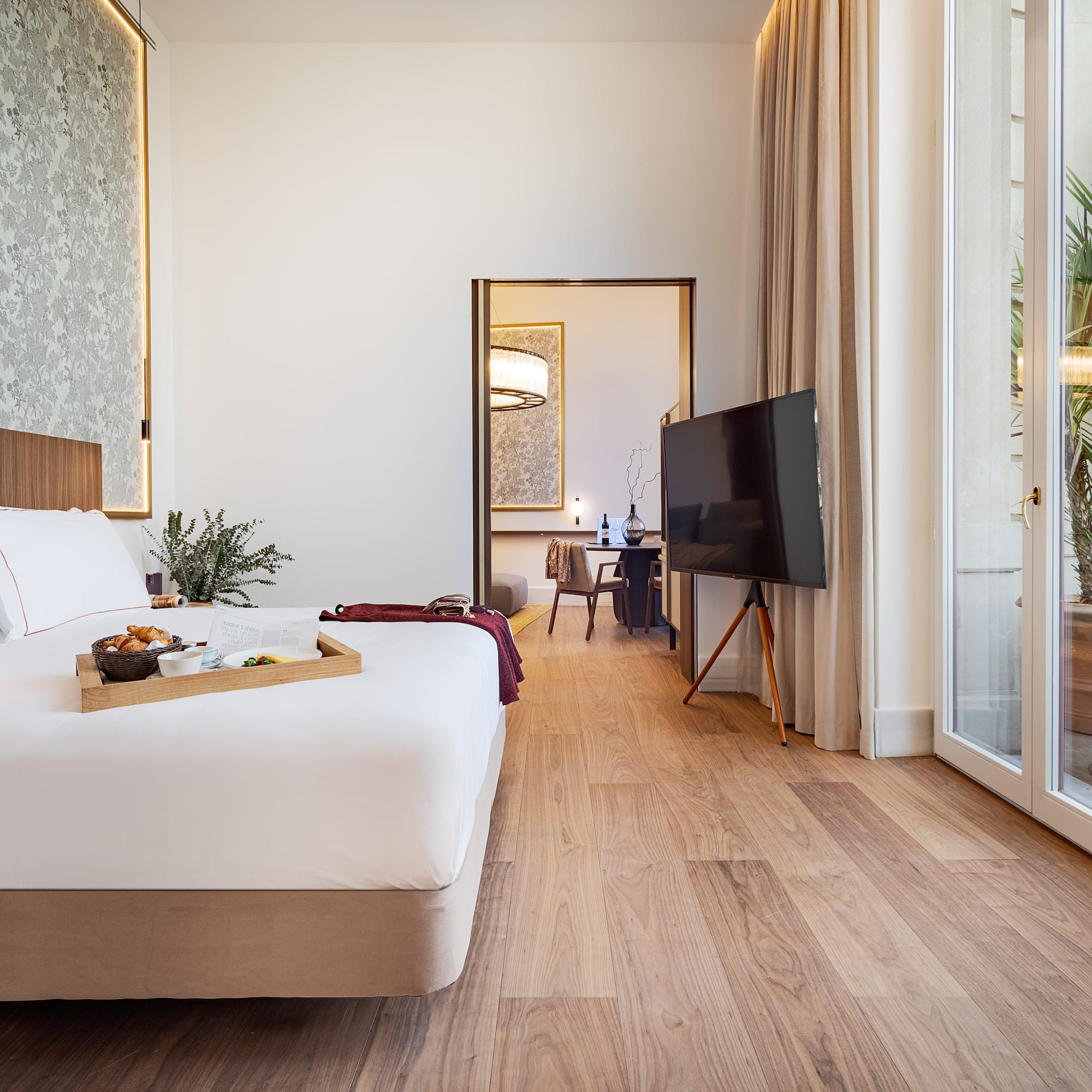 a bedroom with a tv and a tray of food