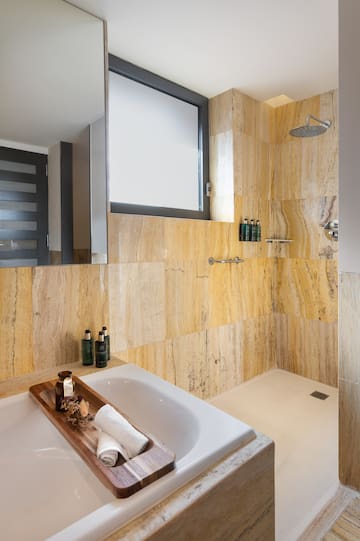 a bathroom with a bathtub and shower