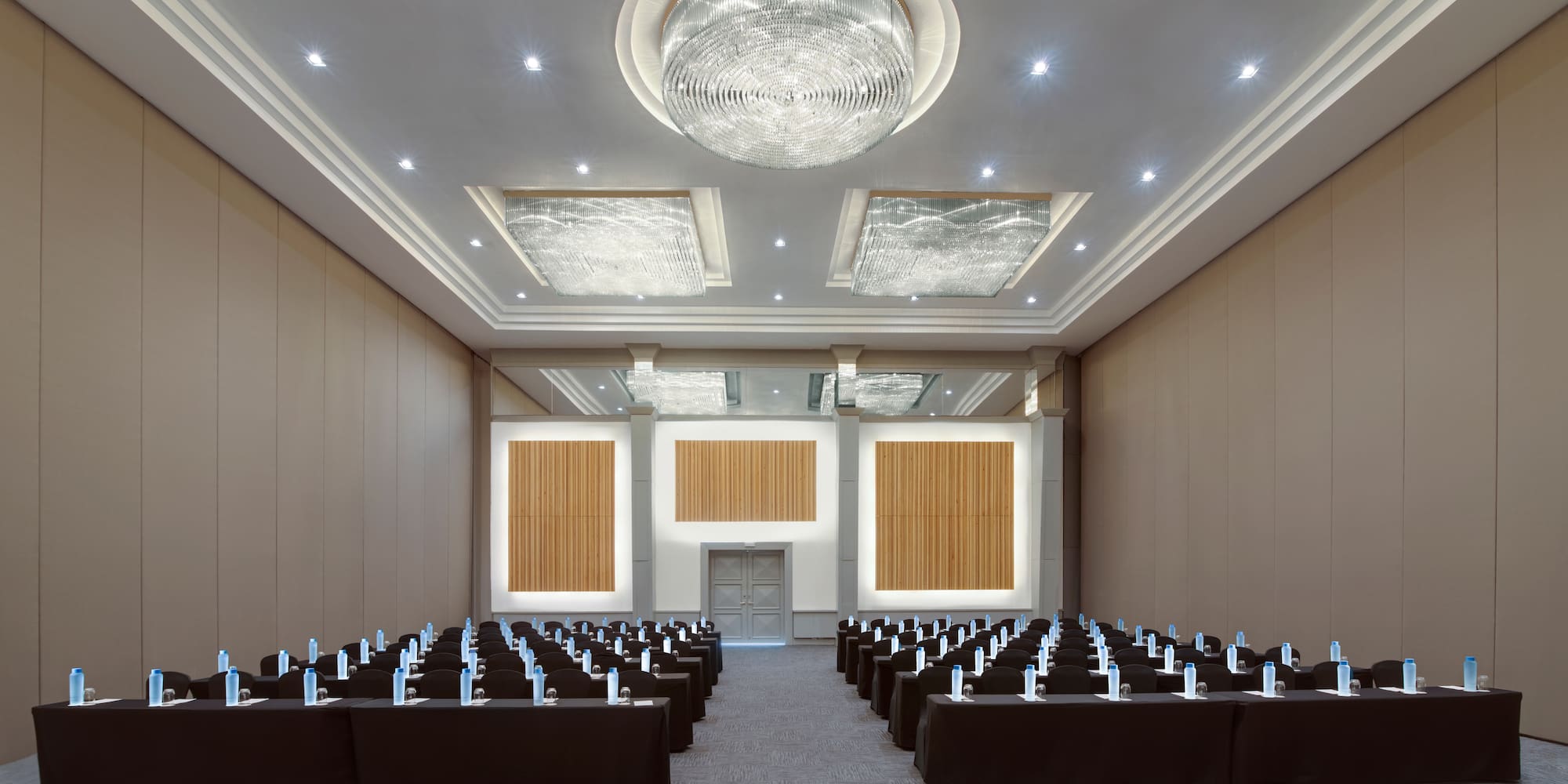 a room with rows of chairs and a chandelier