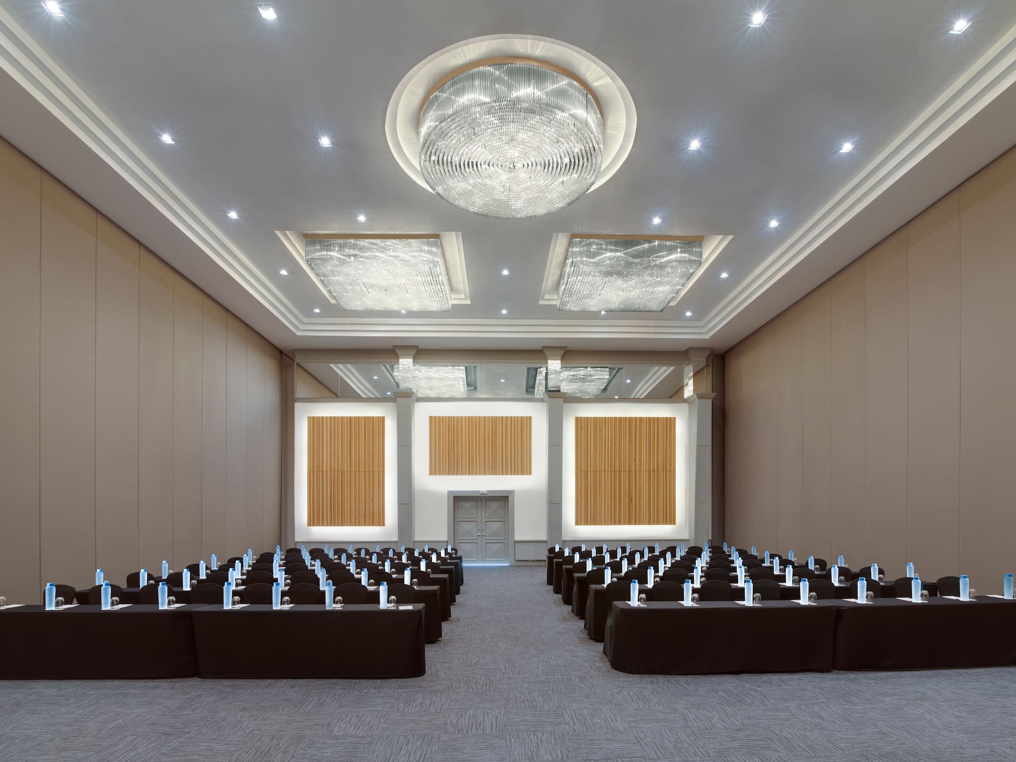 a room with rows of chairs and a chandelier