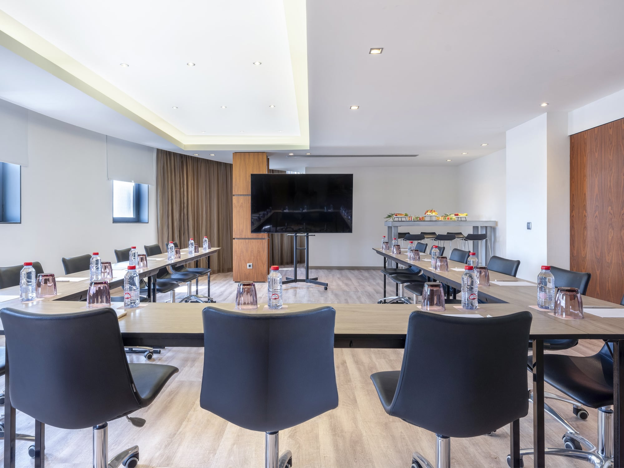 a room with tables and chairs and a television
