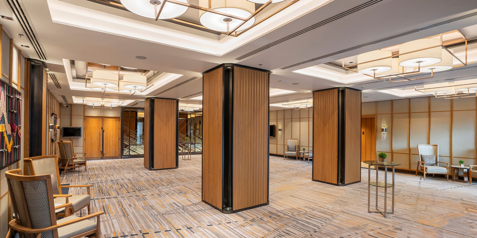 a room with a large column and chairs