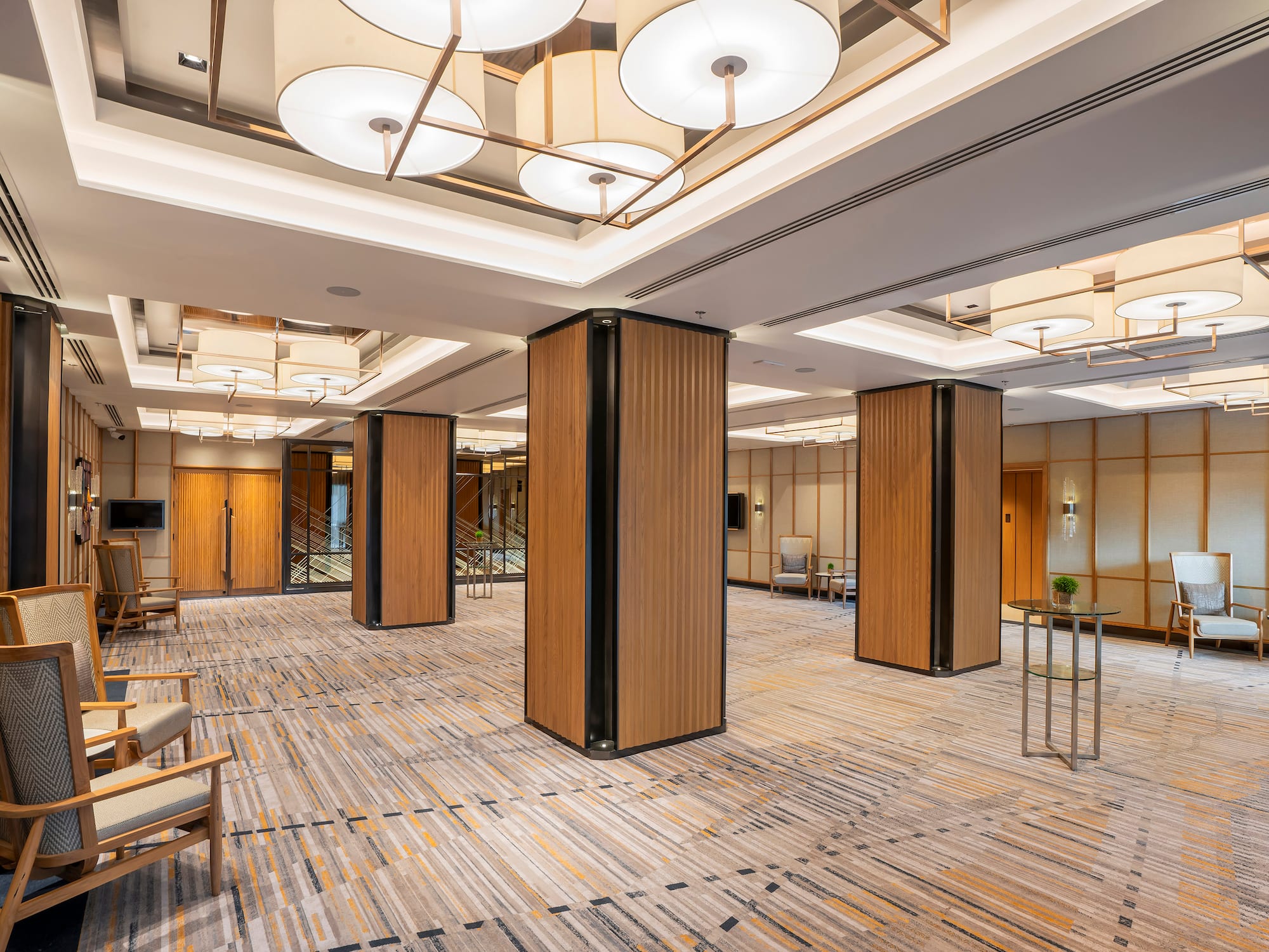 a room with a large column and chairs