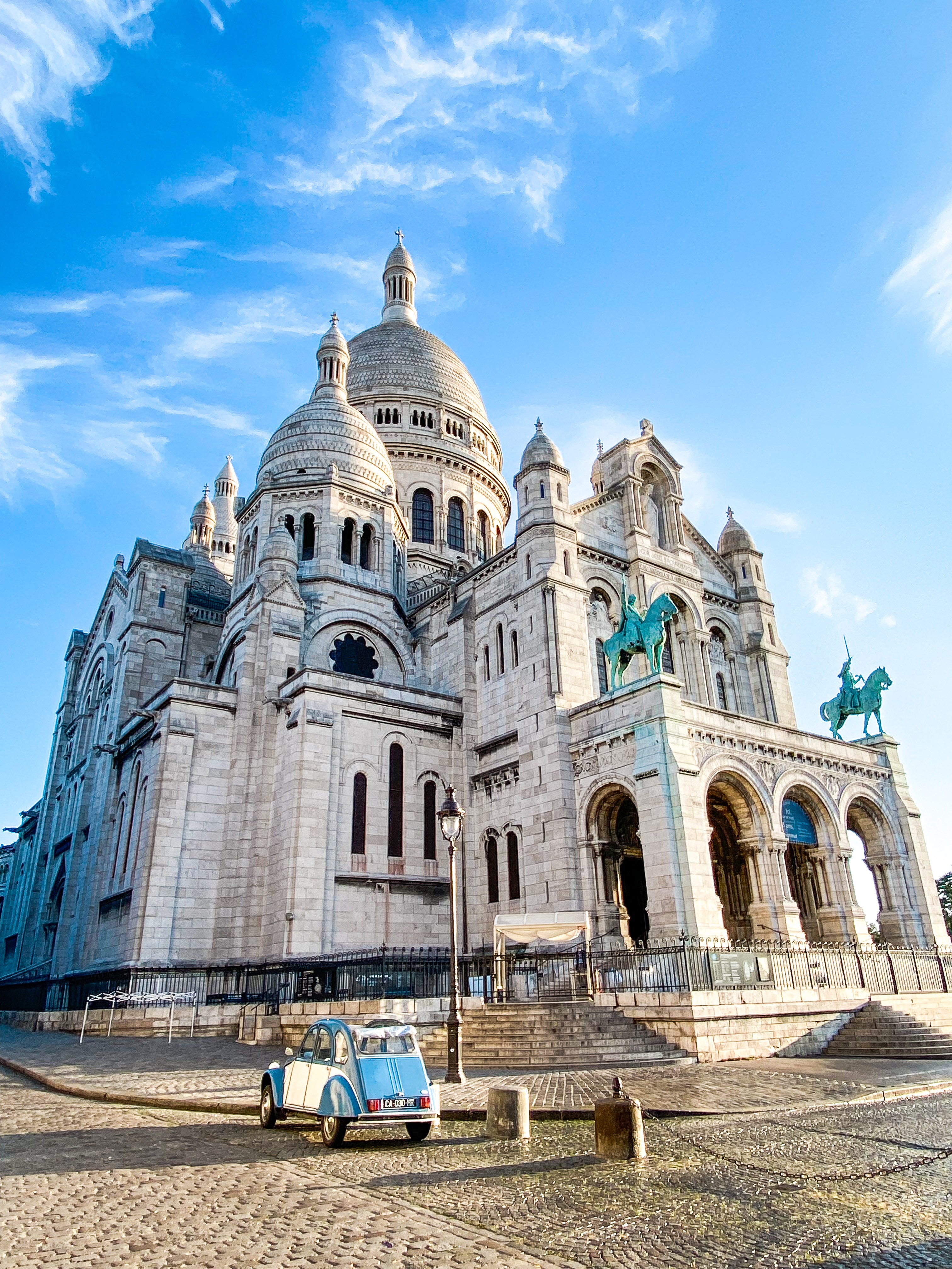 Sacré-Cœur Basilica, Montmartre, Paris, and vintage blue Citroën 2CV.