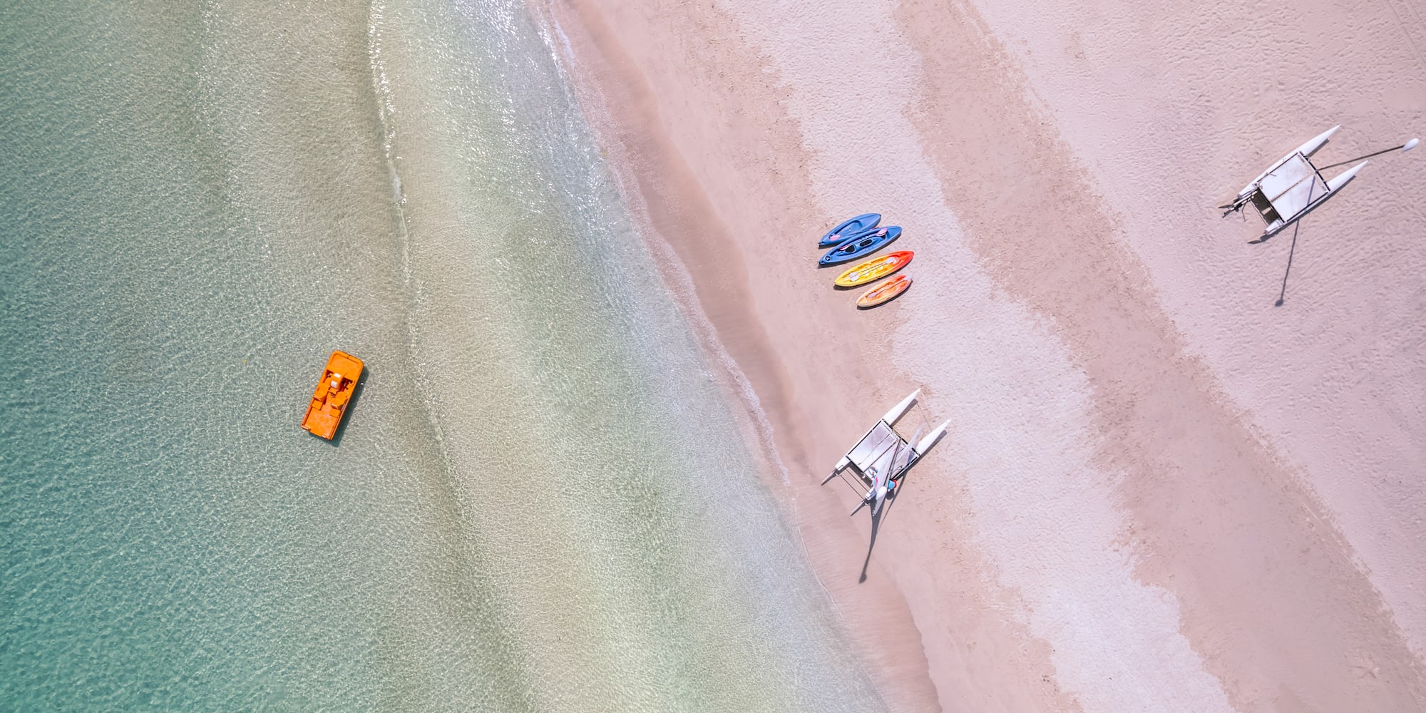 a beach with boats and a boat on the beach
