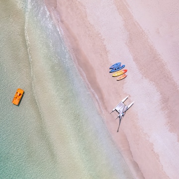 a beach with boats and a boat on the beach