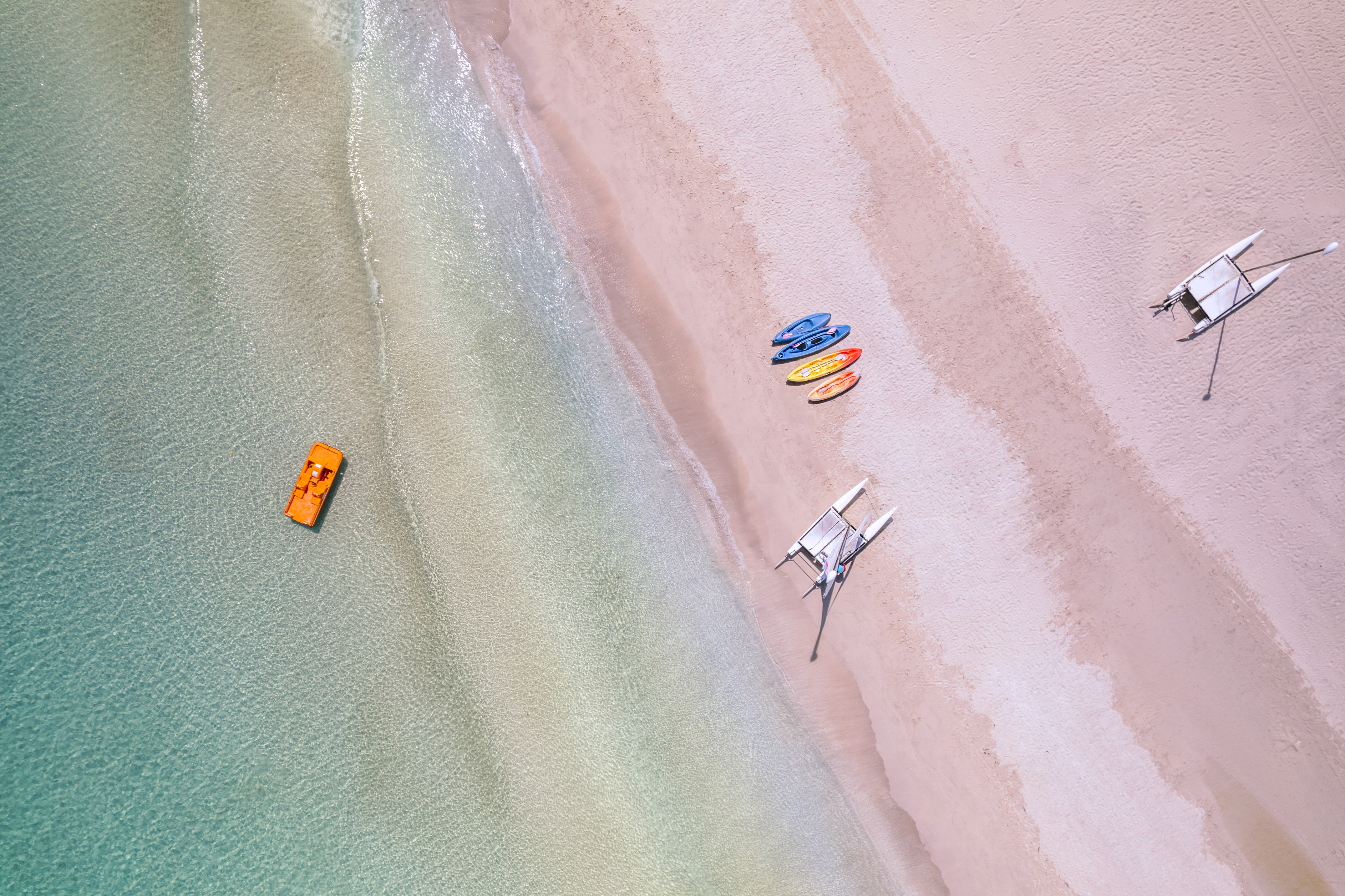 a beach with boats and a boat on the beach