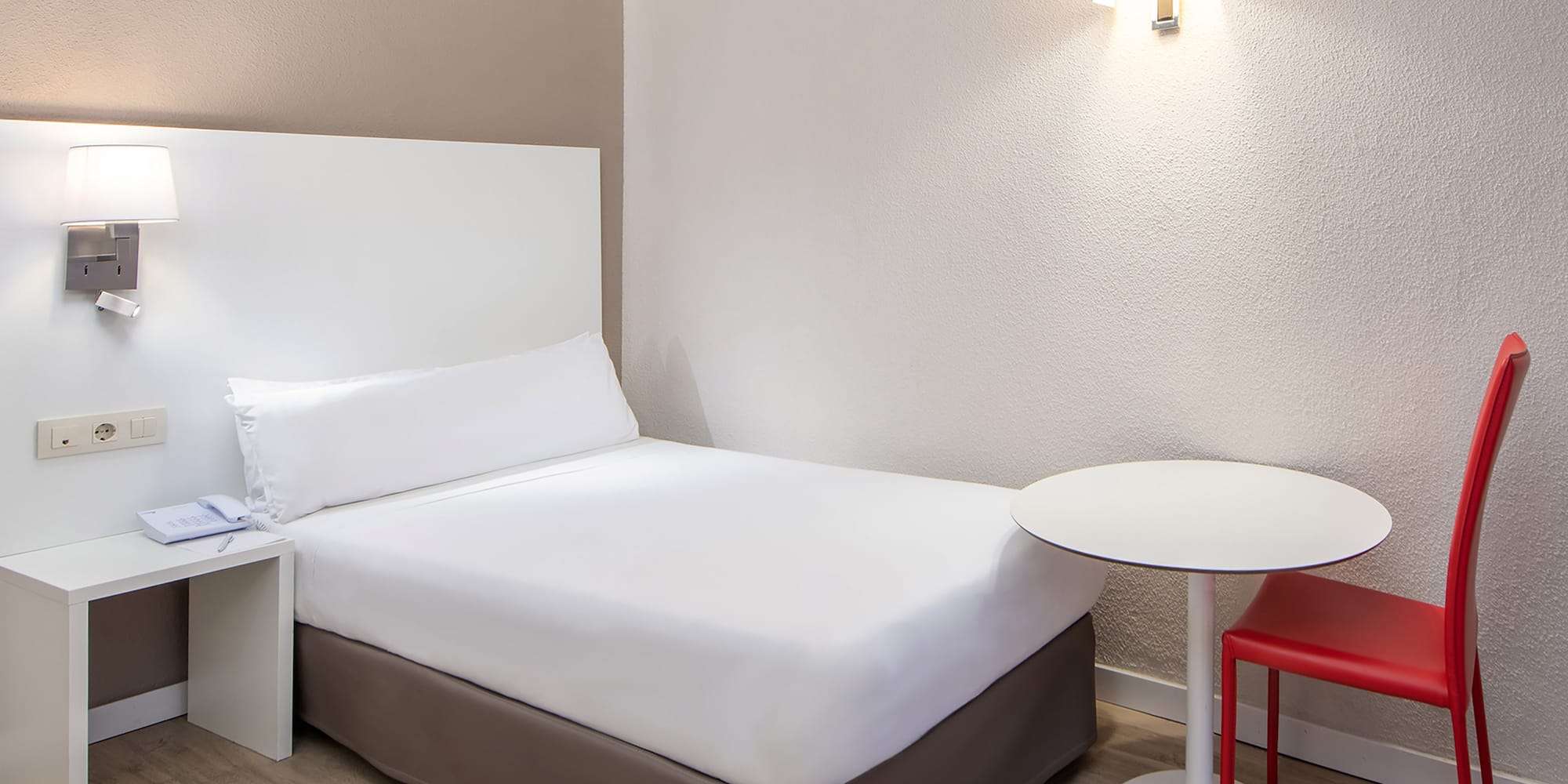 a bed with a table and chair