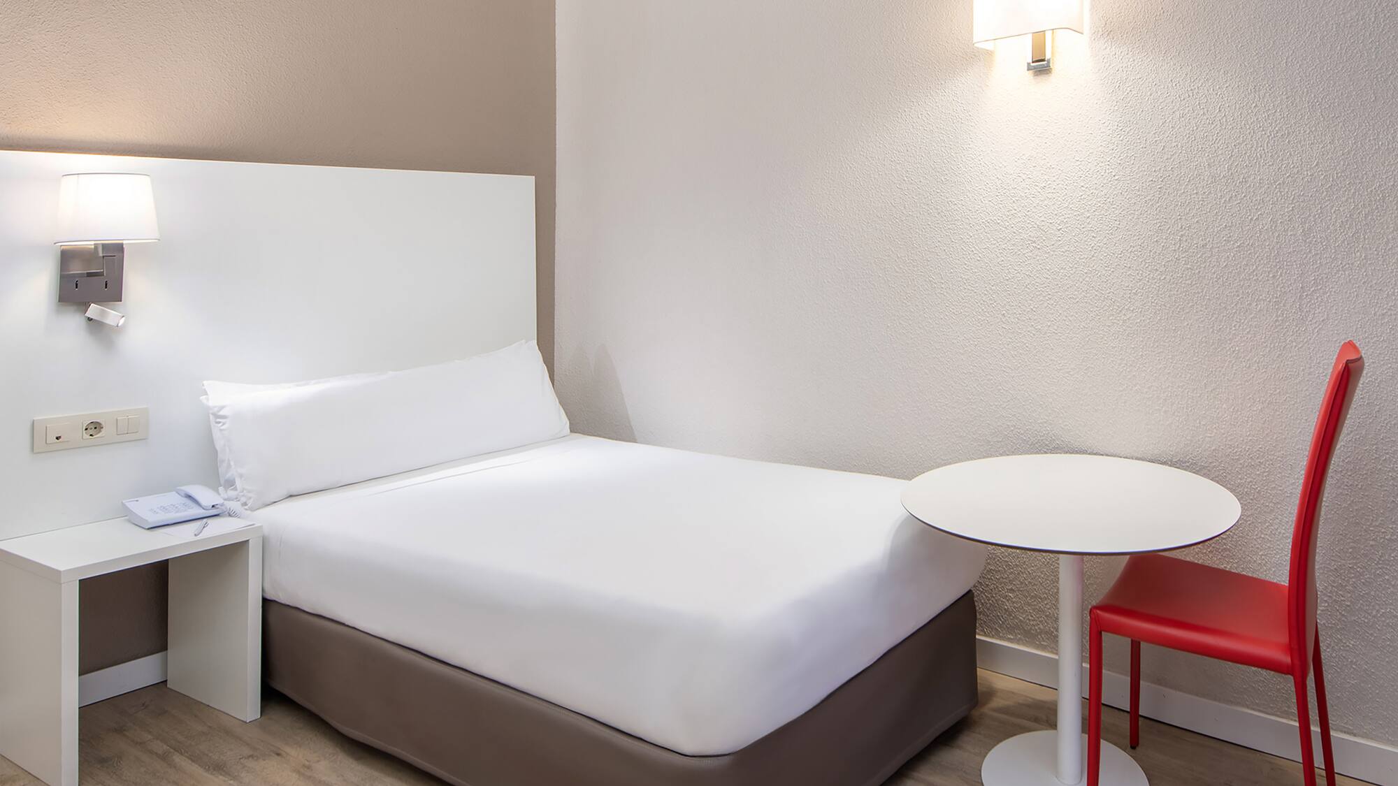 a bed with a table and chair