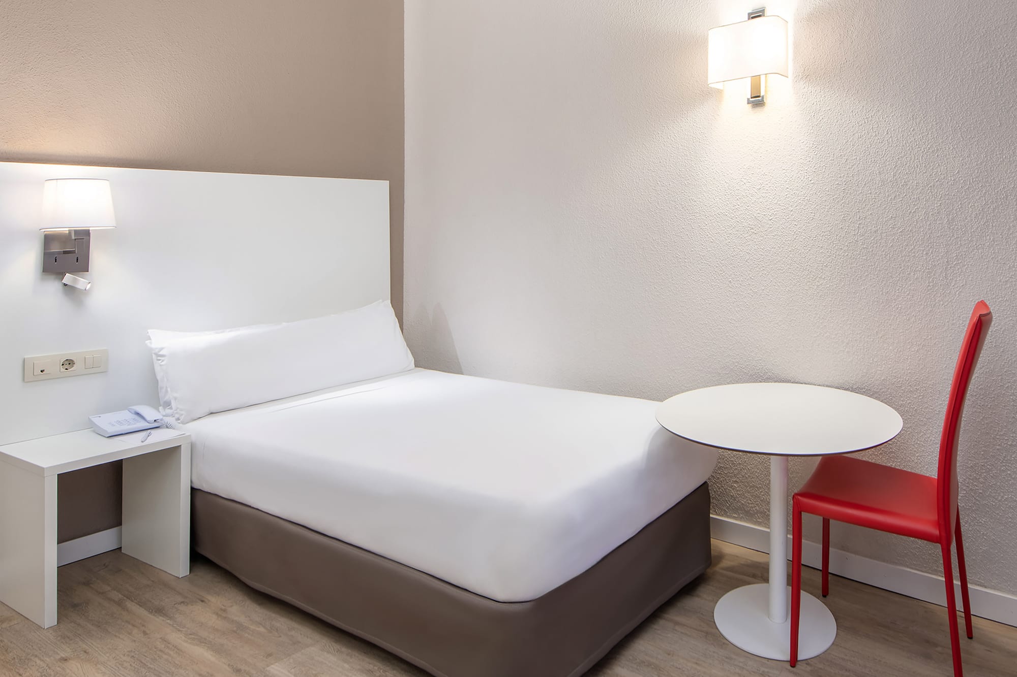 a bed with a table and chair