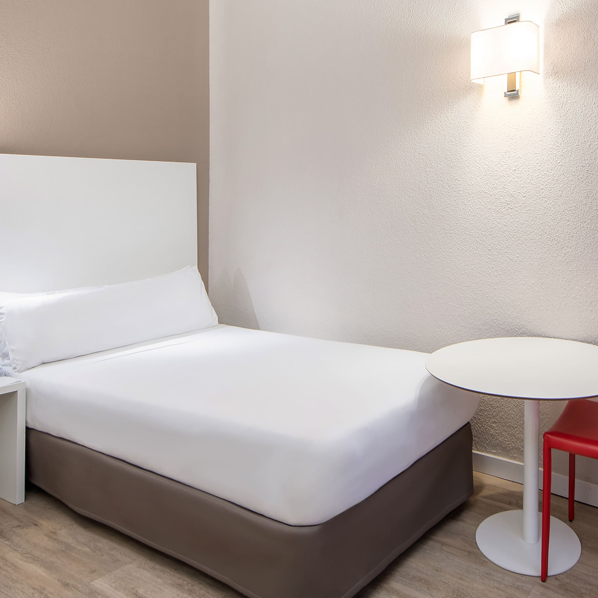 a bed with a table and chair