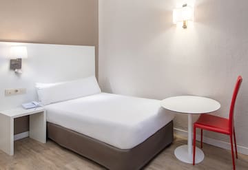 a bed with a table and chair