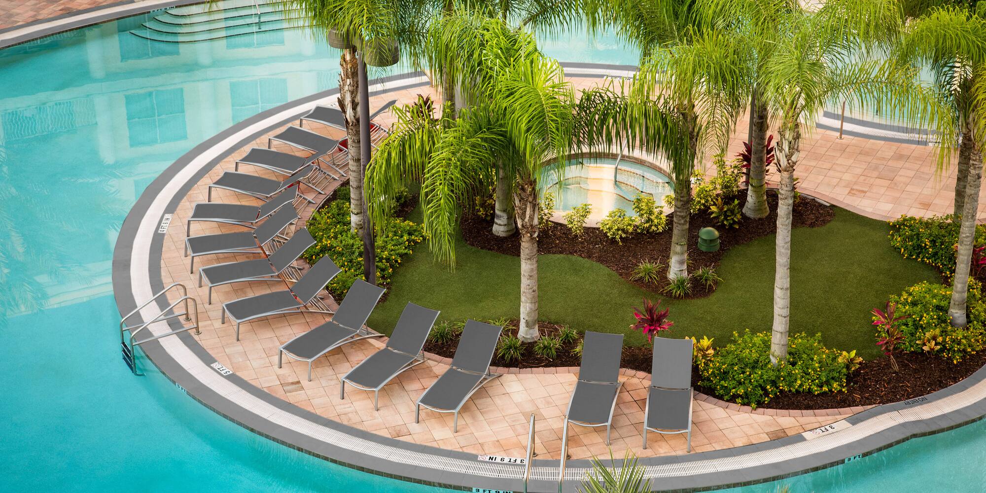 a pool with lounge chairs and palm trees