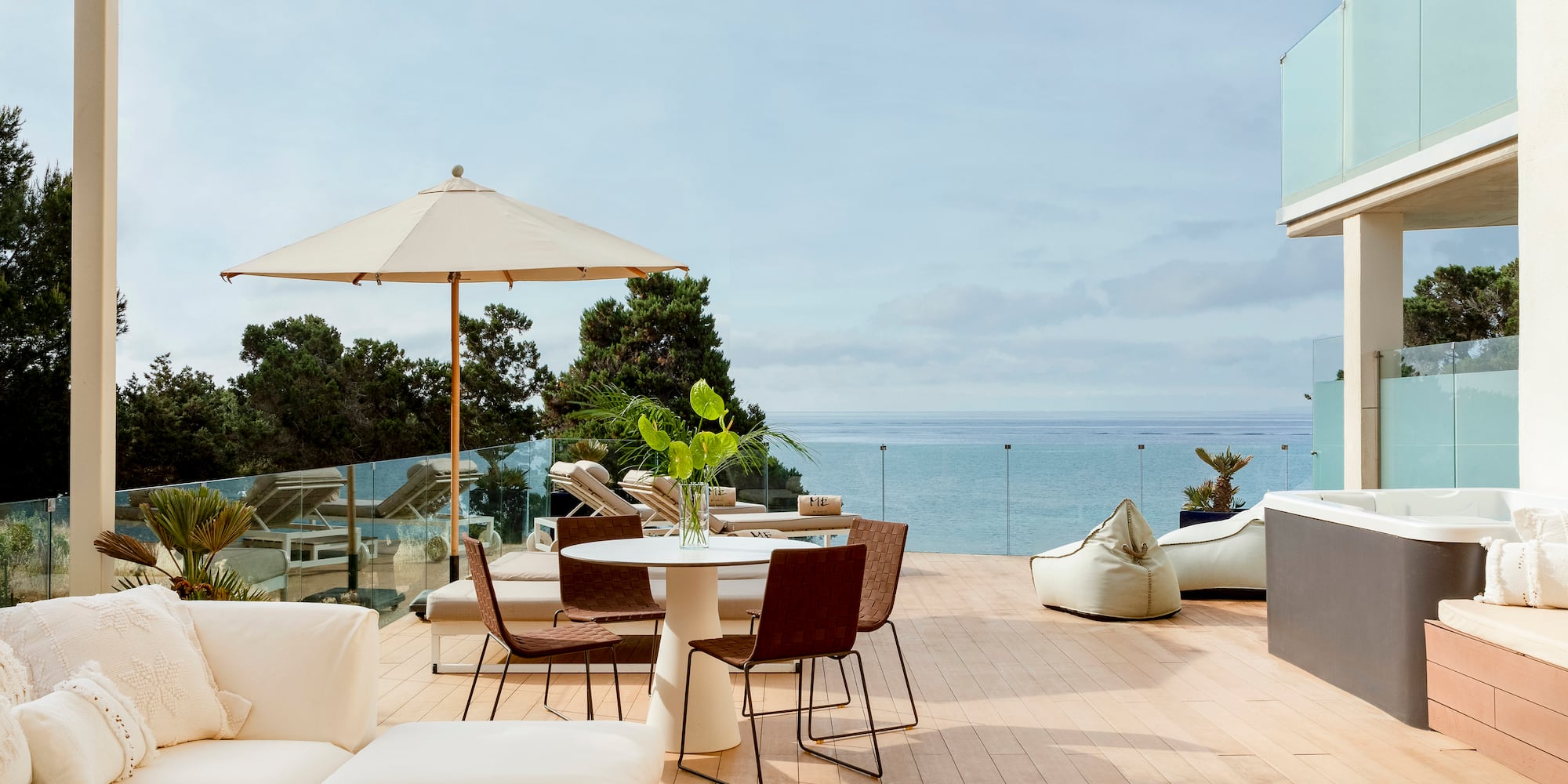 a patio with a table and chairs and umbrellas