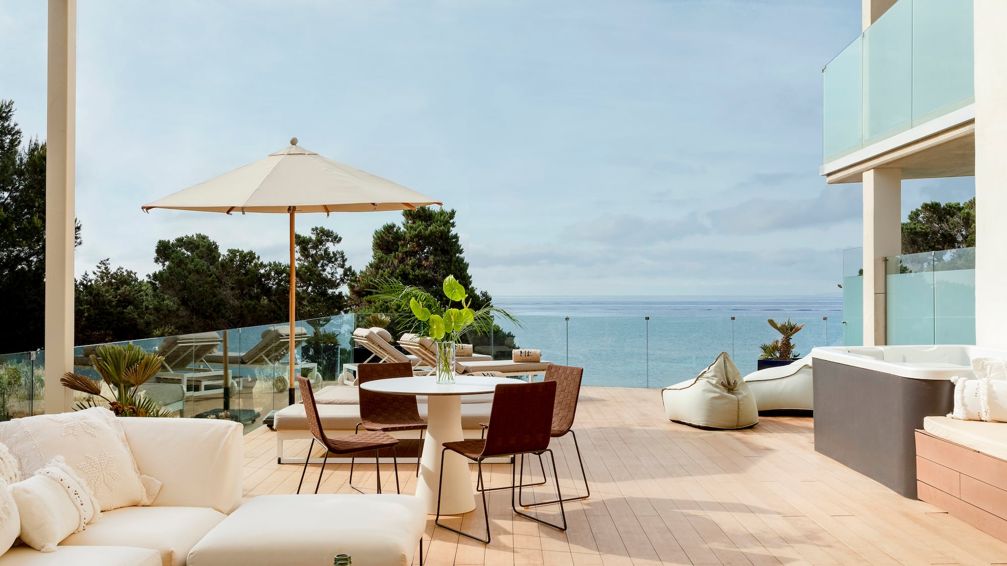 a patio with a table and chairs and umbrellas